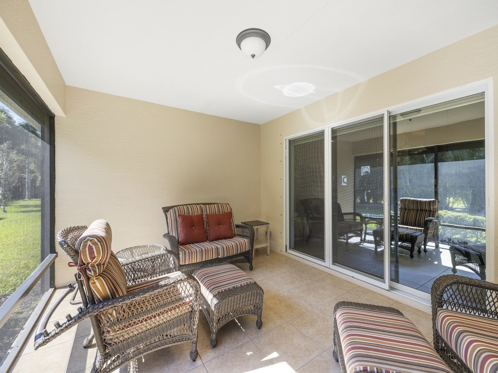 605 Monarch Way Sebastian, FL 32958 - Photo 24 of 36 a living room with furniture and a floor to ceiling window
