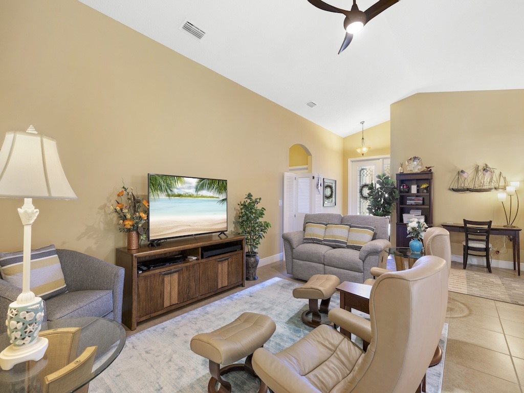 605 Monarch Way Sebastian, FL 32958 - Photo 3 of 36 a living room with furniture and a flat screen tv