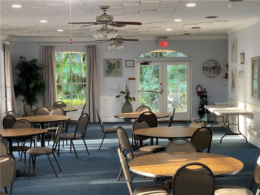605 Monarch Way Sebastian, FL 32958 - Photo 31 of 36 a dining room with furniture a chandelier and wooden floor
