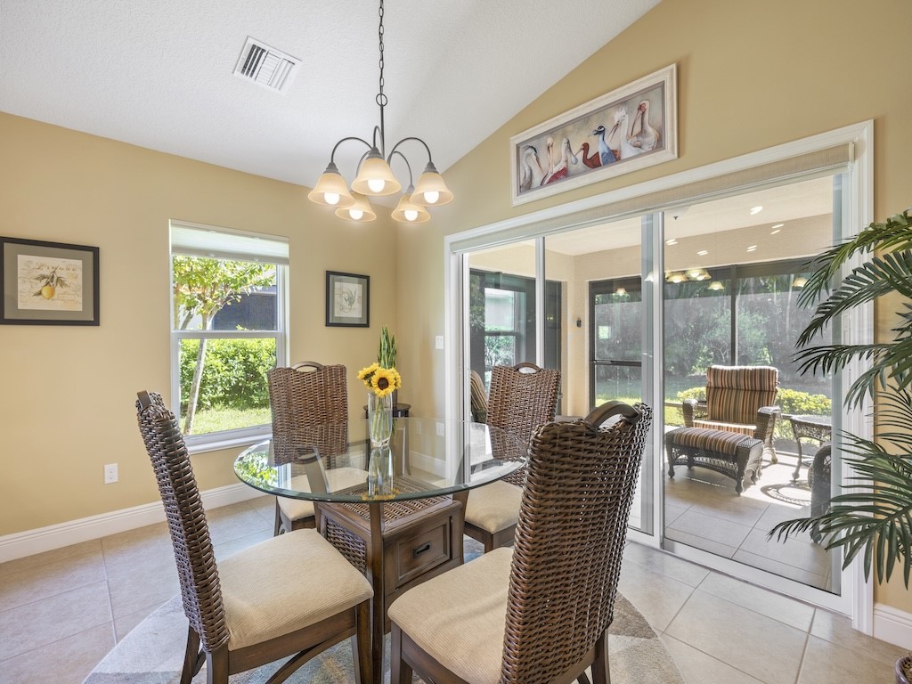 605 Monarch Way Sebastian, FL 32958 - Photo 6 of 36 a dining room with furniture a chandelier and large windows