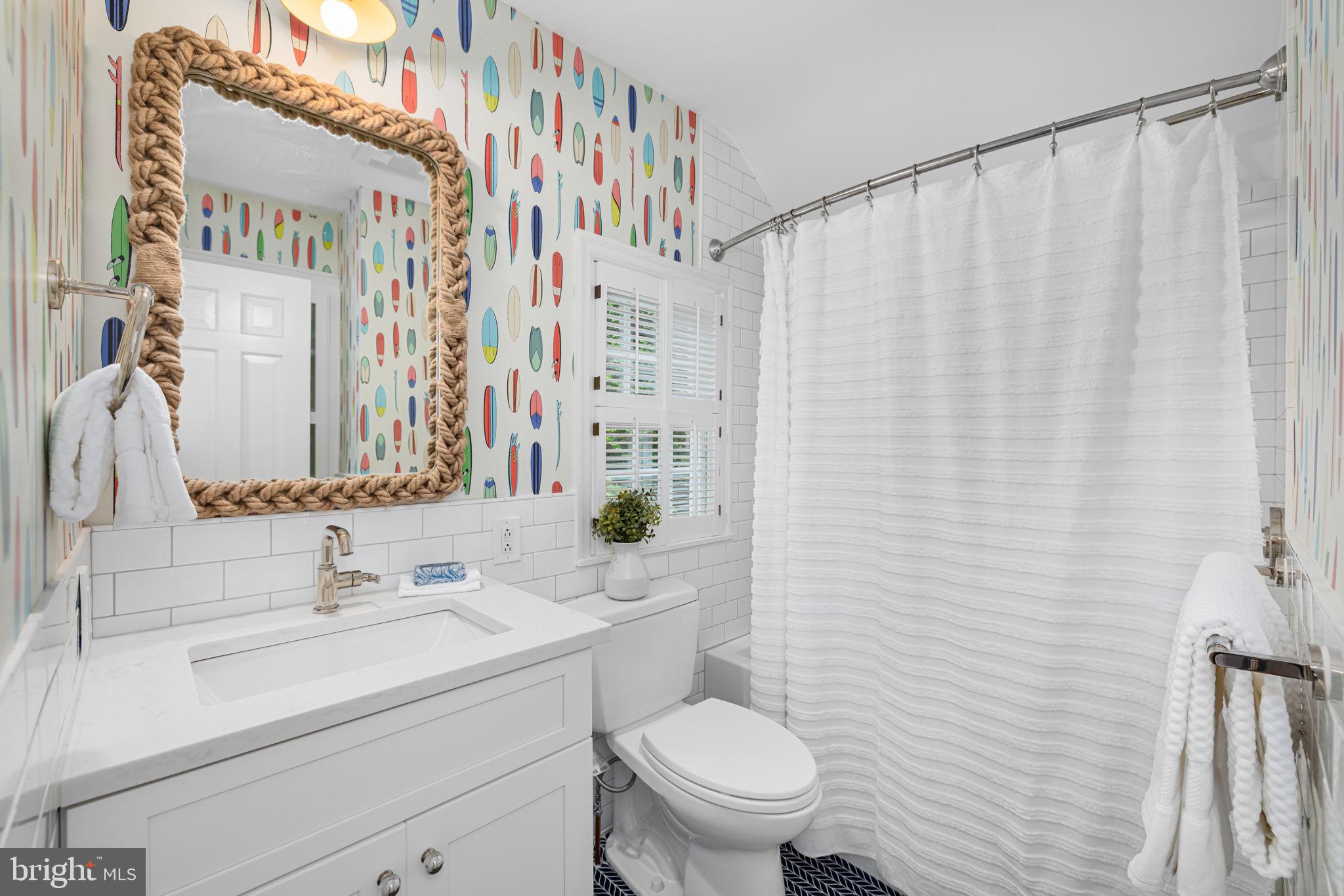 4822 Upton Street Northwest Washington, DC 20016 - Photo 21 of 48 a bathroom with a sink a toilet and shower curtain