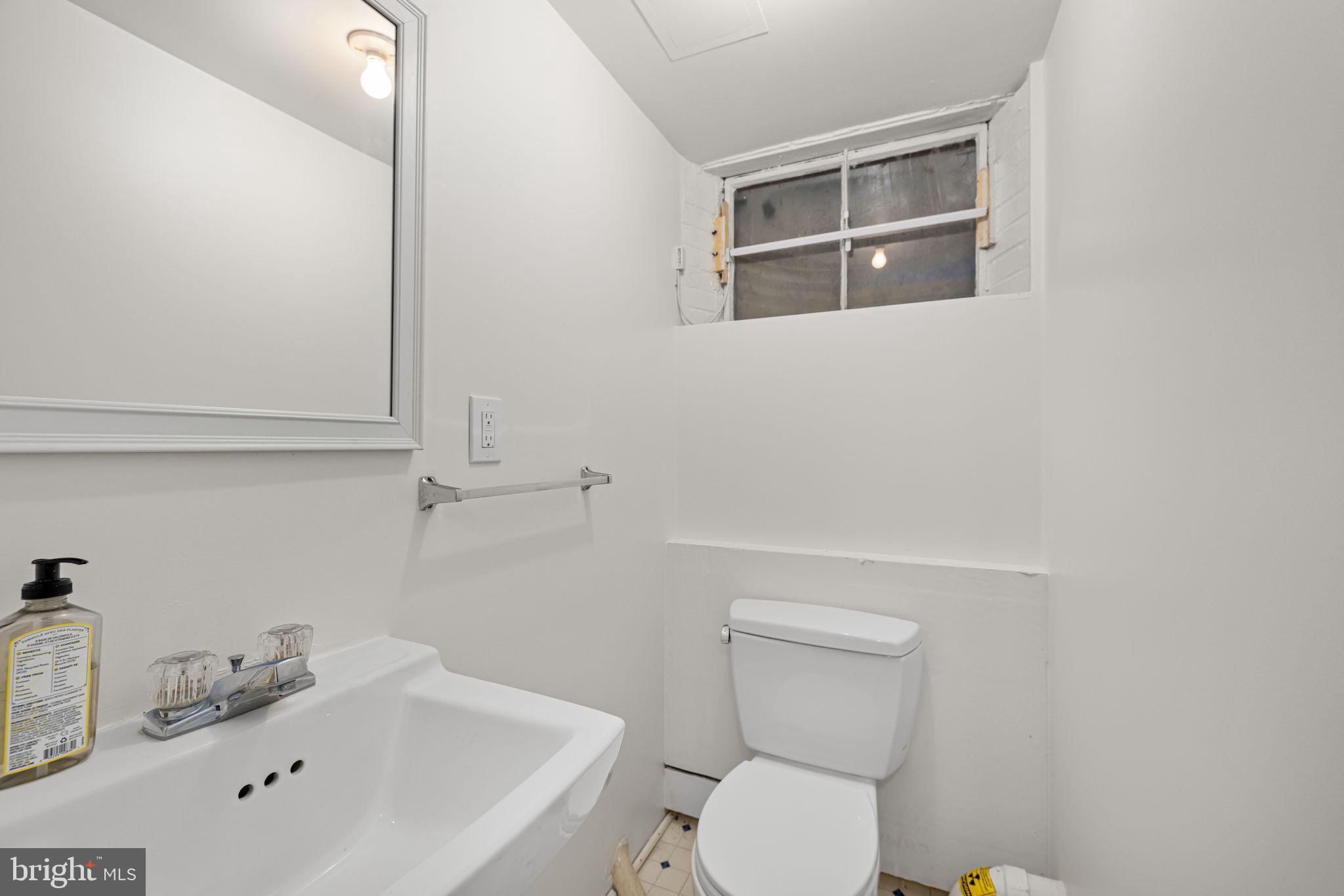 4822 Upton Street Northwest Washington, DC 20016 - Photo 42 of 48 a bathroom with a sink a toilet and mirror