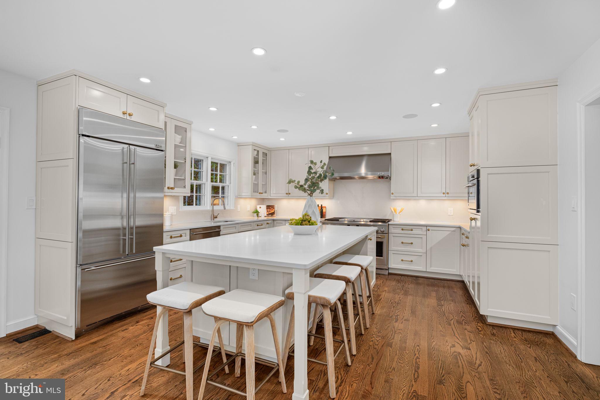 4822 Upton Street Northwest Washington, DC 20016 - Photo 8 of 48 a kitchen with stainless steel appliances refrigerator dining table and chairs
