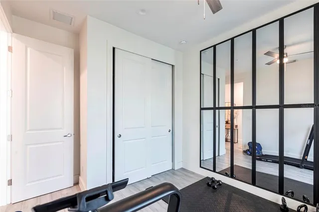 a view of a room with a window and wooden floor