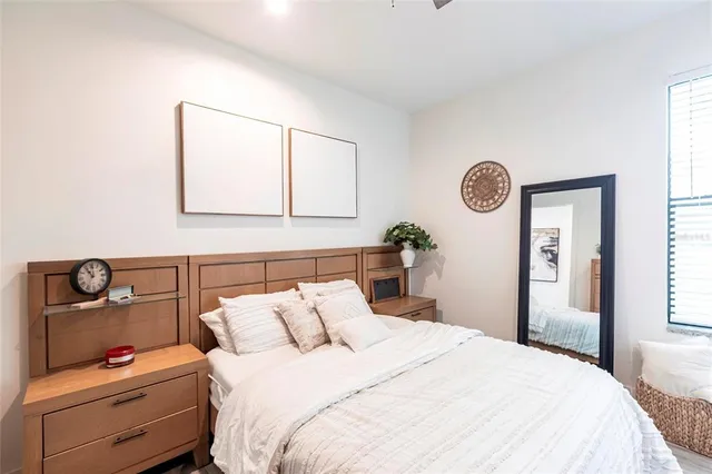 a bedroom with a bed and a window