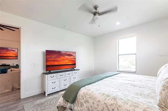 a bedroom with a bed and a flat screen tv