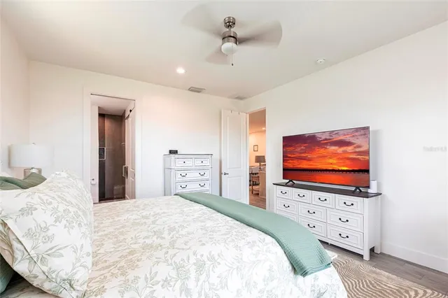 a bedroom with a bed and a flat screen tv in it