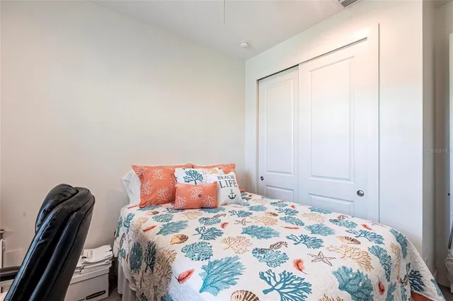 a bedroom with a bed and a painting on the wall