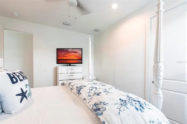 a bedroom with a bed and a flat screen tv