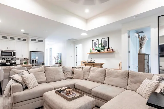 a living room with furniture a couch and a window