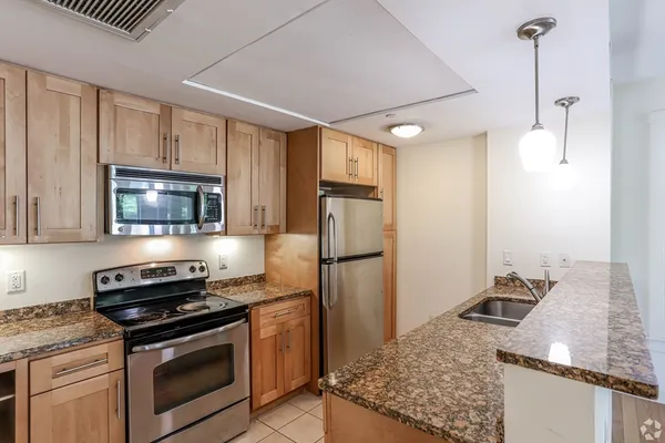 a kitchen with a stove and a refrigerator
