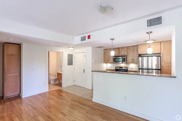 a kitchen with stainless steel appliances a refrigerator and a stove top oven