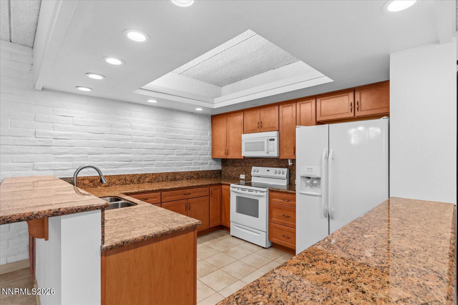 1200 Riverside Drive, Unit 1229 Reno, NV 89503 - Photo 26 of 51 a kitchen with stainless steel appliances granite countertop a sink and a refrigerator
