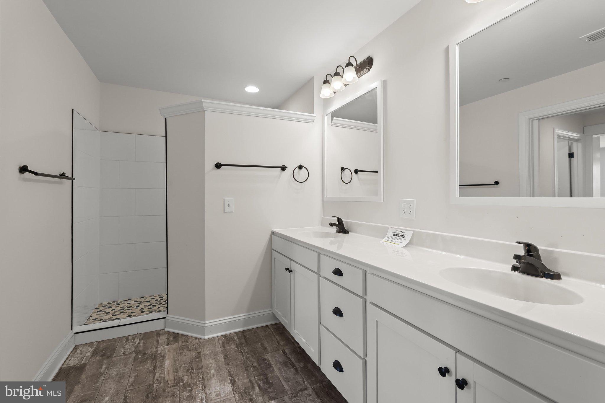 7832 Old Receiver Road Frederick, MD 21702 - Photo 28 of 57 a spacious bathroom with double sink and mirror
