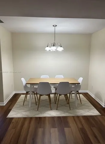 a dining room with furniture and chandelier
