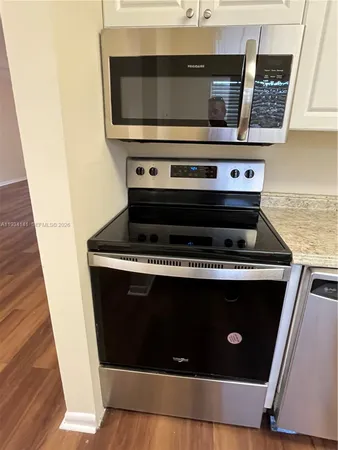 a stove top oven sitting inside of a kitchen