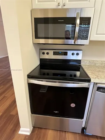 a stove top oven sitting inside of a kitchen