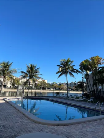 a view of a swimming pool with a table and chairs