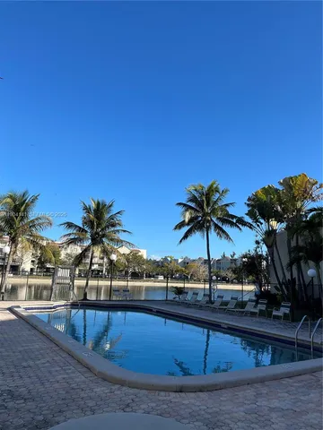 a view of a swimming pool with a table and chairs