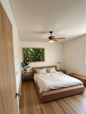 a bedroom with a large bed and a window