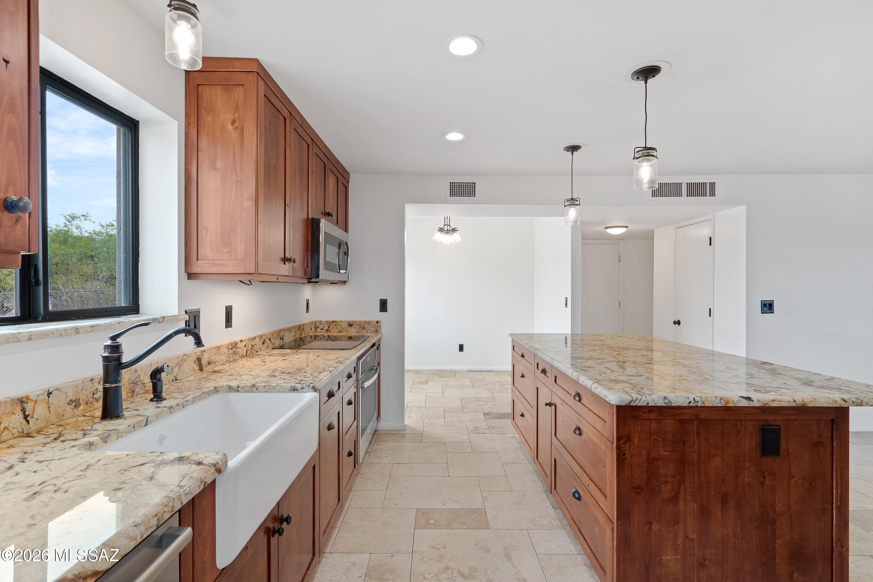9420 East Ravine Trail Tucson, AZ 85749 - Photo 13 of 39 a kitchen with a stove sink and cabinets