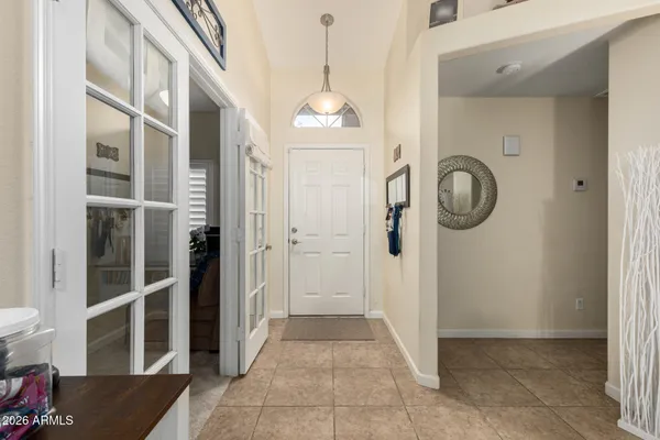 a view of a hallway with entryway wooden floor and front door