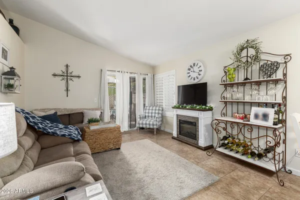 a living room with furniture a flat screen tv and a fireplace