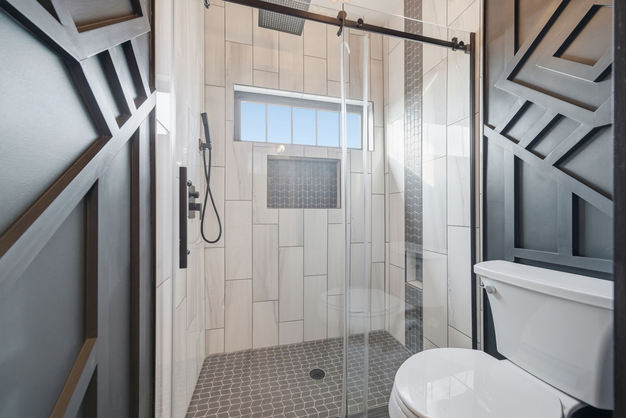 1918 Todville Road Seabrook, TX 77586 - Photo 25 of 41 Striking third-level shower with bold geometric tile, frameless glass, and upscale fixtures that highlight the home’s modern bayfront design.