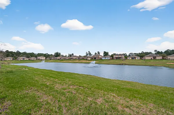 a view of a lake with houses in the background