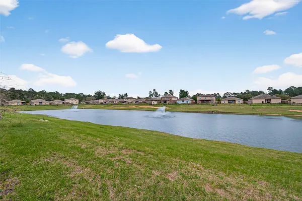 a view of a lake with houses in the background