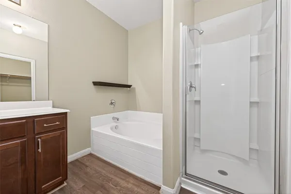 a bathroom with a tub a sink and a shower
