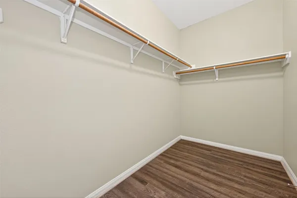 a view of a room with wooden floor