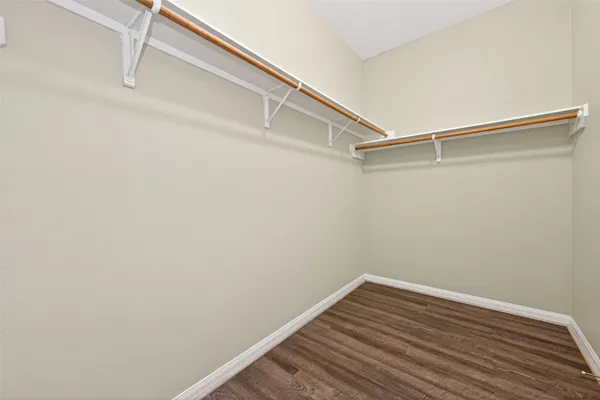 a view of a room with wooden floor