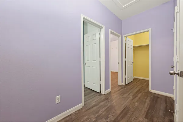 an empty room with wooden floor and closet