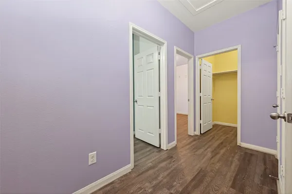 an empty room with wooden floor and closet