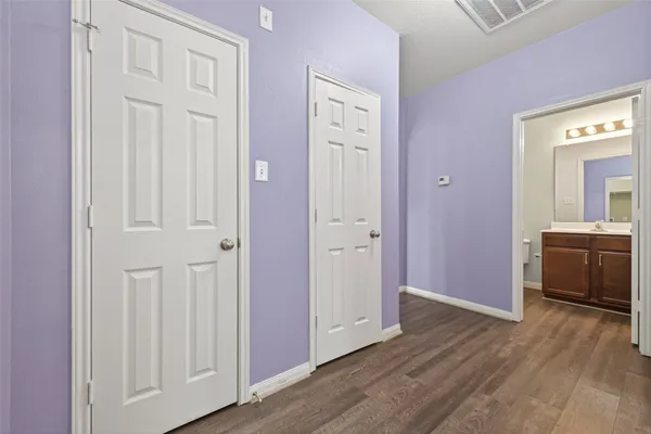wooden floor with white cabinets and wooden floor