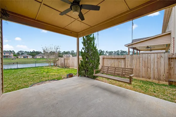 a view of a backyard with wooden fence