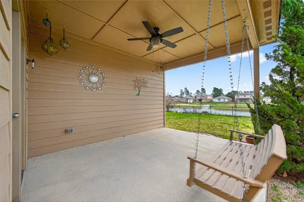 a view of a chair and table in backyard of the house