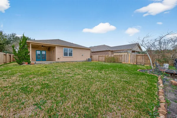 a view of a house with a big yard and large tree