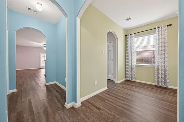 wooden floor in an empty room with a window