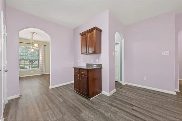 a view of a kitchen with wooden floor and a sink