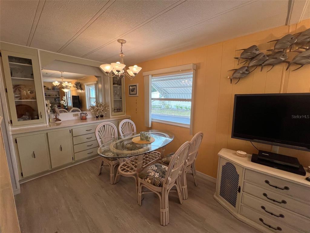 52 Frangipani Circle Largo, FL 33770 - Photo 12 of 33 a view of a dining room with furniture and chandelier