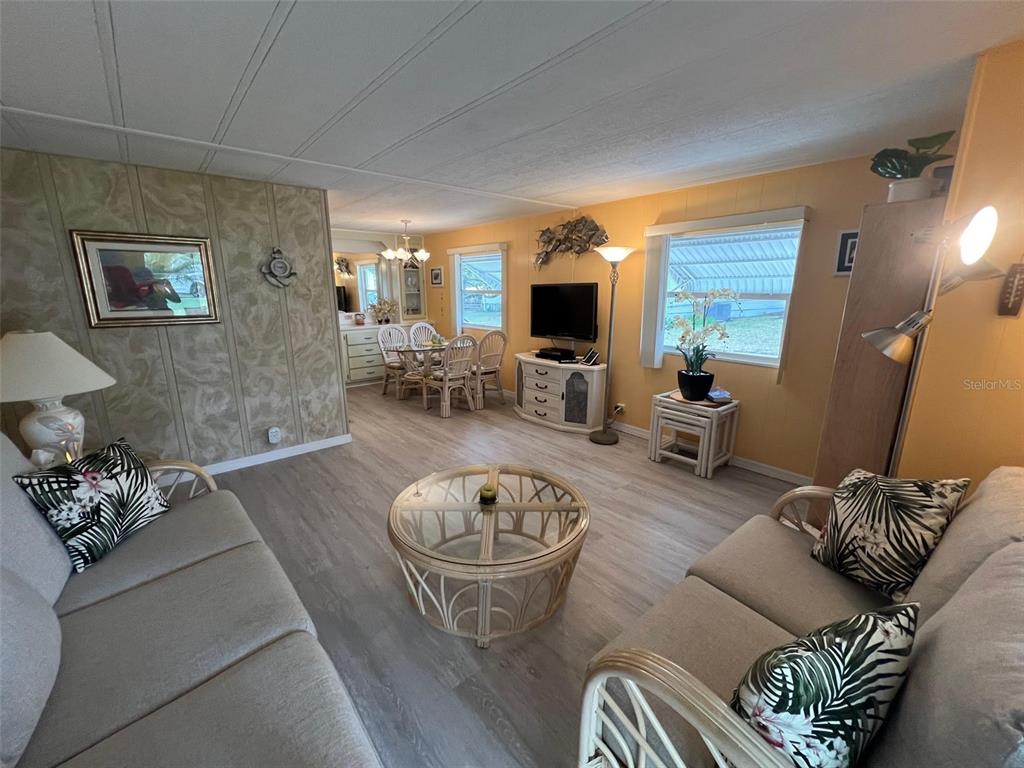 52 Frangipani Circle Largo, FL 33770 - Photo 13 of 33 a living room with furniture a flat screen tv and a large window