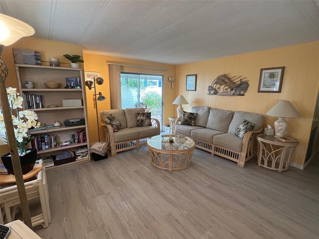 52 Frangipani Circle Largo, FL 33770 - Photo 14 of 33 a living room with furniture a rug and a large window