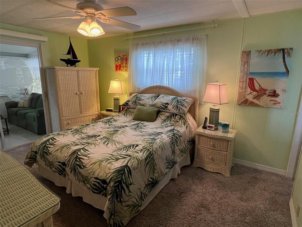 52 Frangipani Circle Largo, FL 33770 - Photo 18 of 33 a bedroom with a bed and a chandelier
