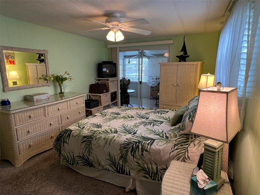 52 Frangipani Circle Largo, FL 33770 - Photo 20 of 33 a bedroom with a bed and a chandelier