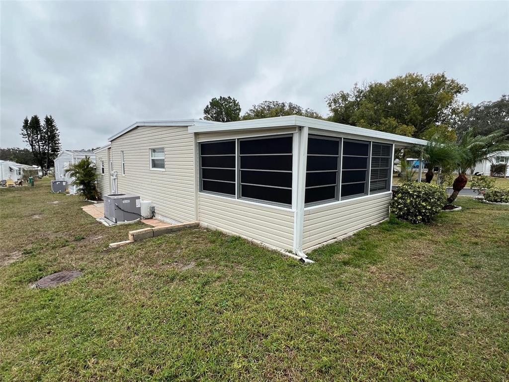 52 Frangipani Circle Largo, FL 33770 - Photo 2 of 33 a view of a house with a yard and garage