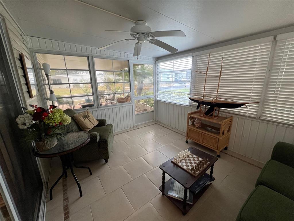 52 Frangipani Circle Largo, FL 33770 - Photo 24 of 33 a living room with furniture and a floor to ceiling window