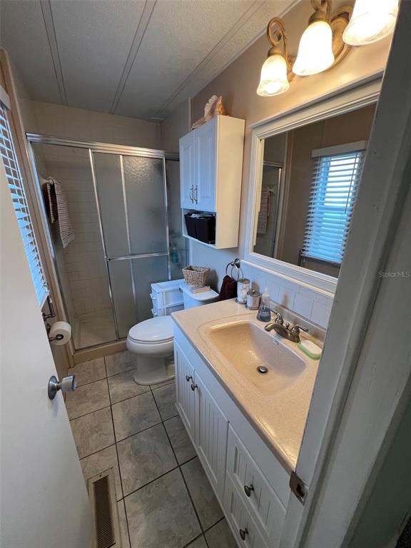 52 Frangipani Circle Largo, FL 33770 - Photo 25 of 33 a bathroom with a sink mirror vanity and toilet