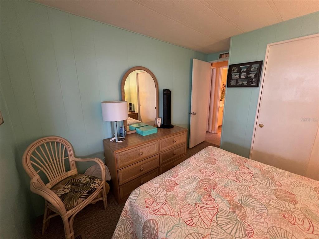 52 Frangipani Circle Largo, FL 33770 - Photo 29 of 33 a bedroom with bed and a chair